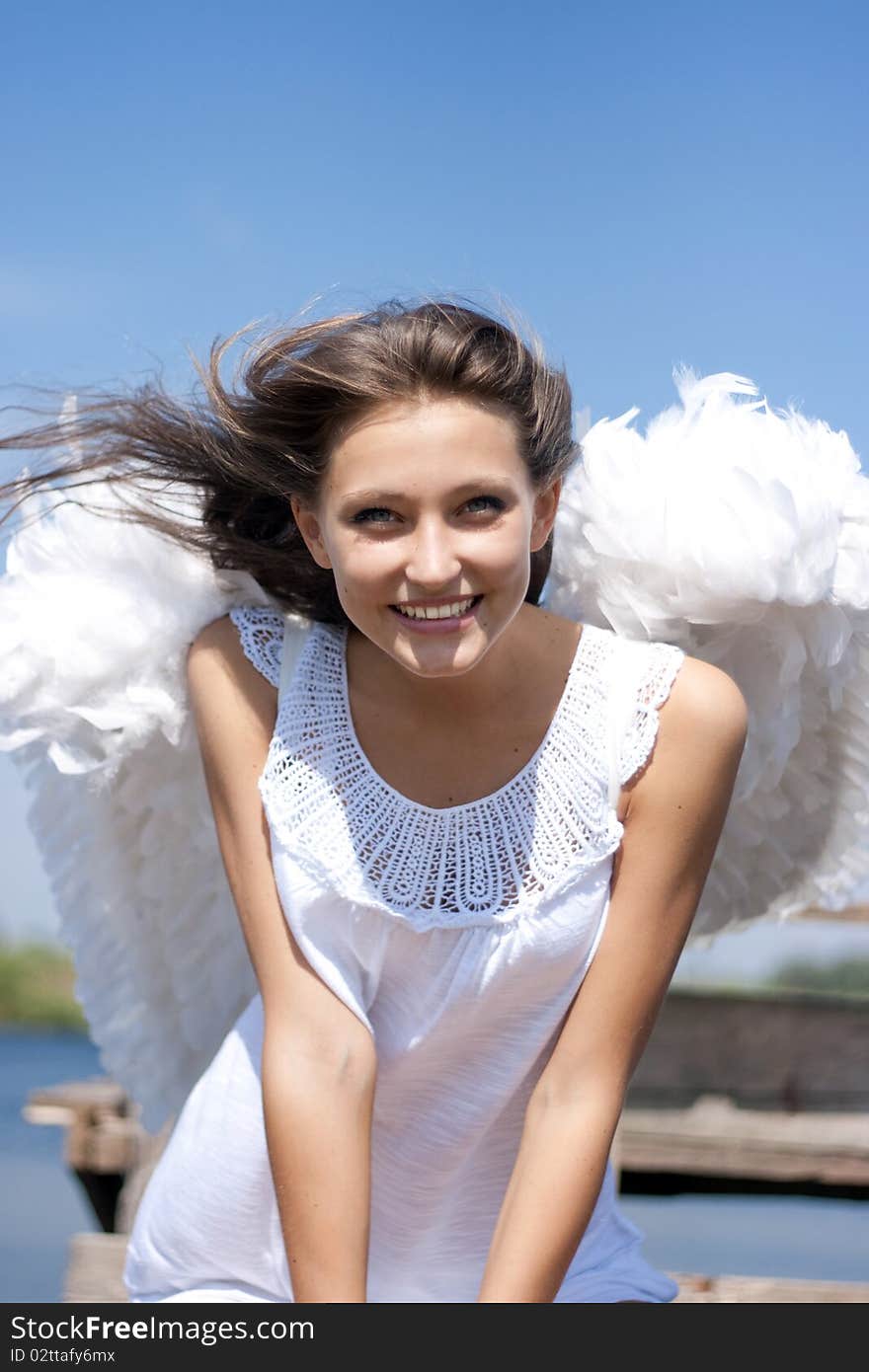 Beautiful happy angel girl and wind