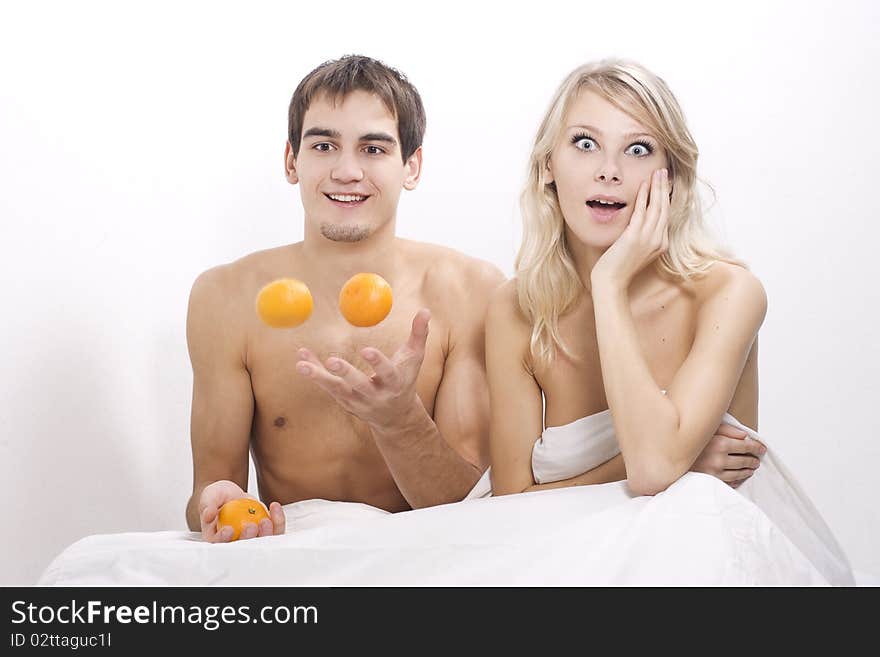 Young couple enjoying breakfast in bed