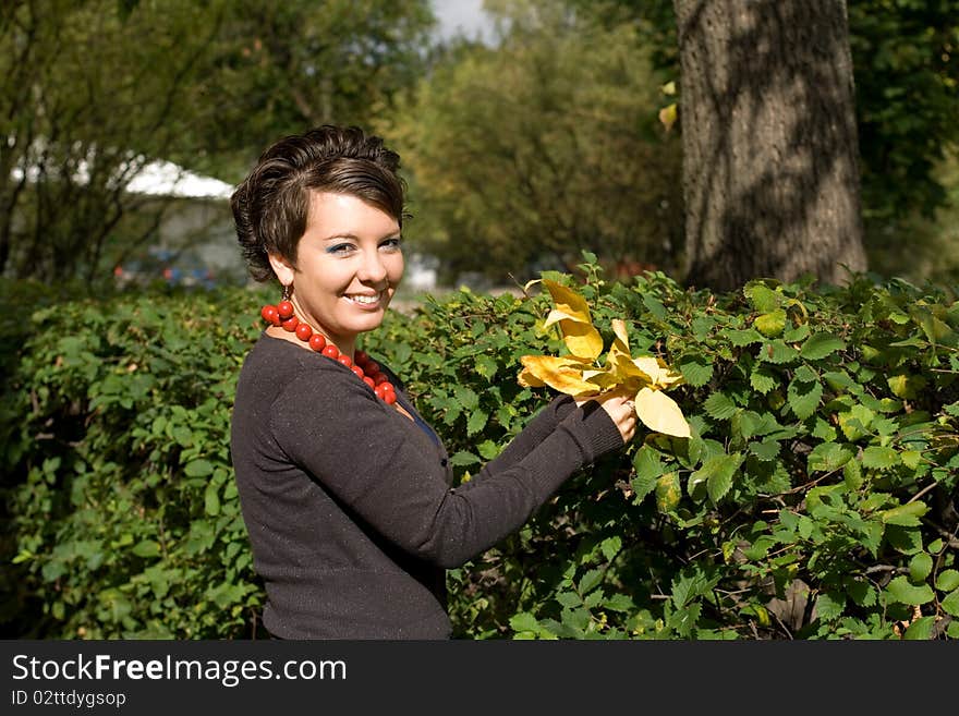 Pretty girl walking in autumn garden