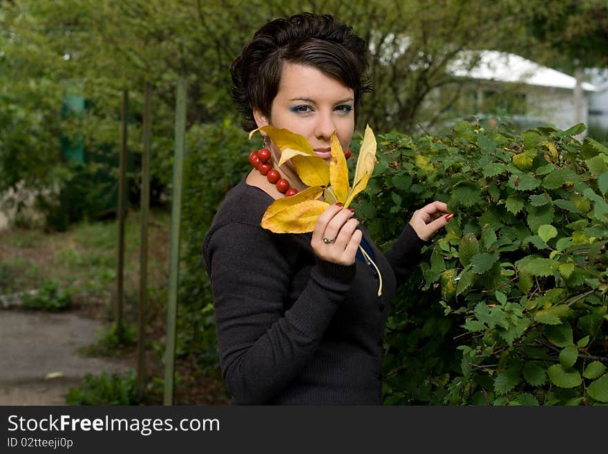 Pretty girl in autumn garden