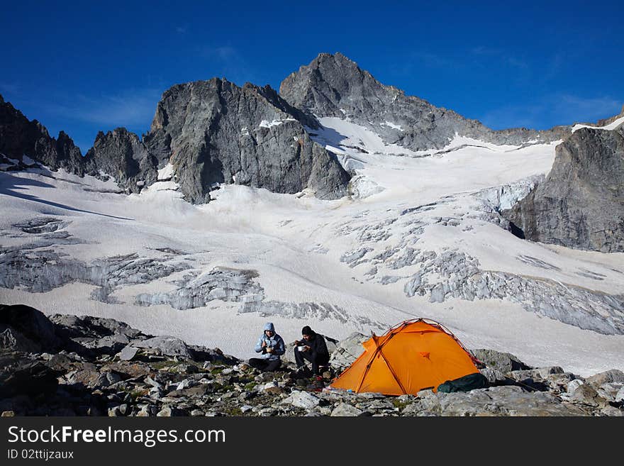 Couple of tourists having a breakfast in high mountains