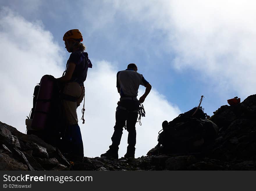 Couple of mountaneers on the top of mountain