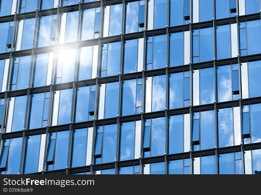 Ray on modern building glass wall