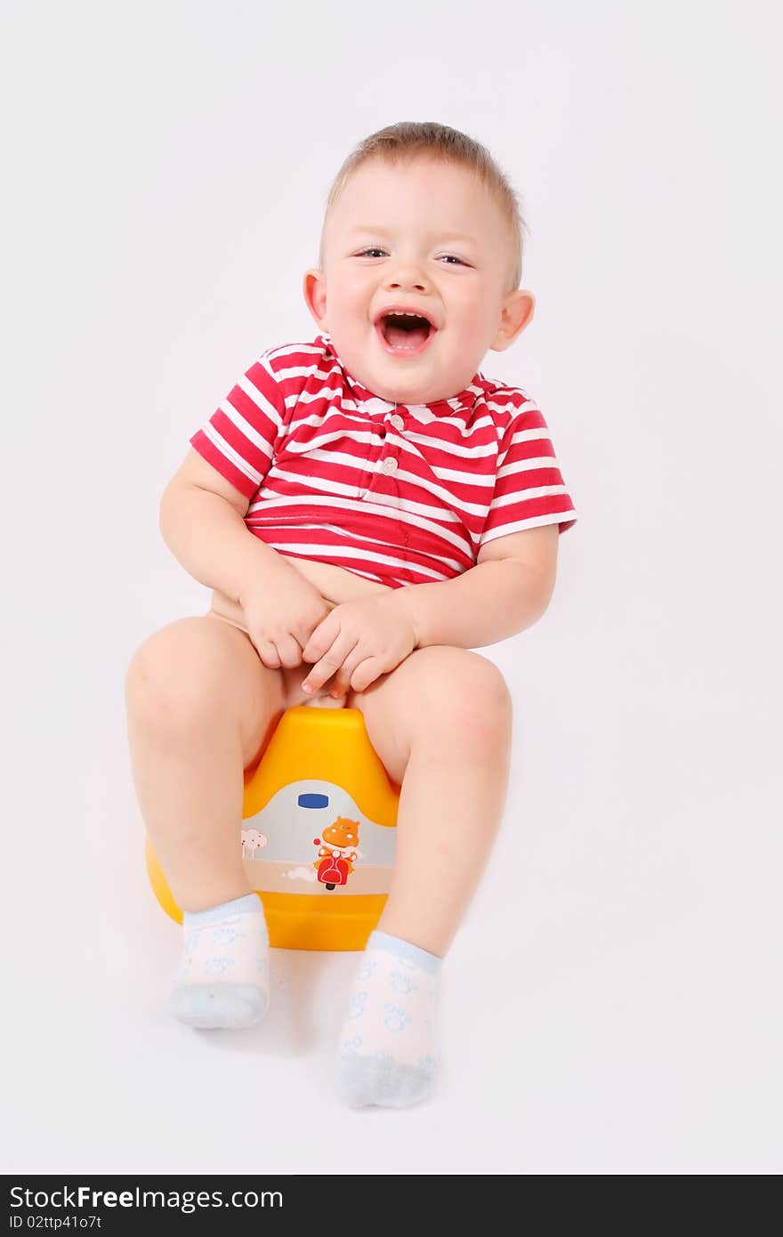 Child is sitting on the pot. Child is sitting on the pot