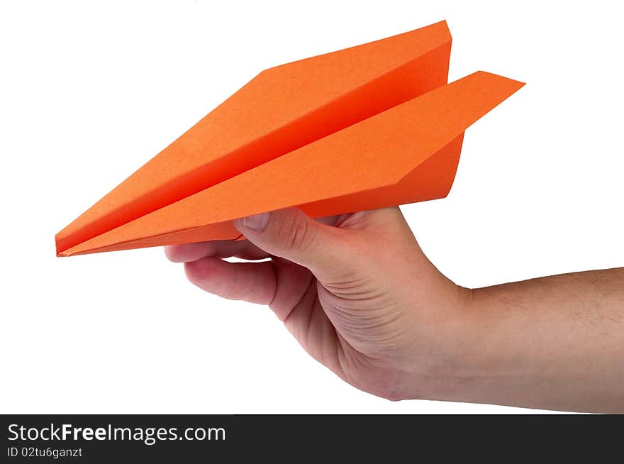 Orange color paper airplane in the hand isolated over white background. Orange color paper airplane in the hand isolated over white background