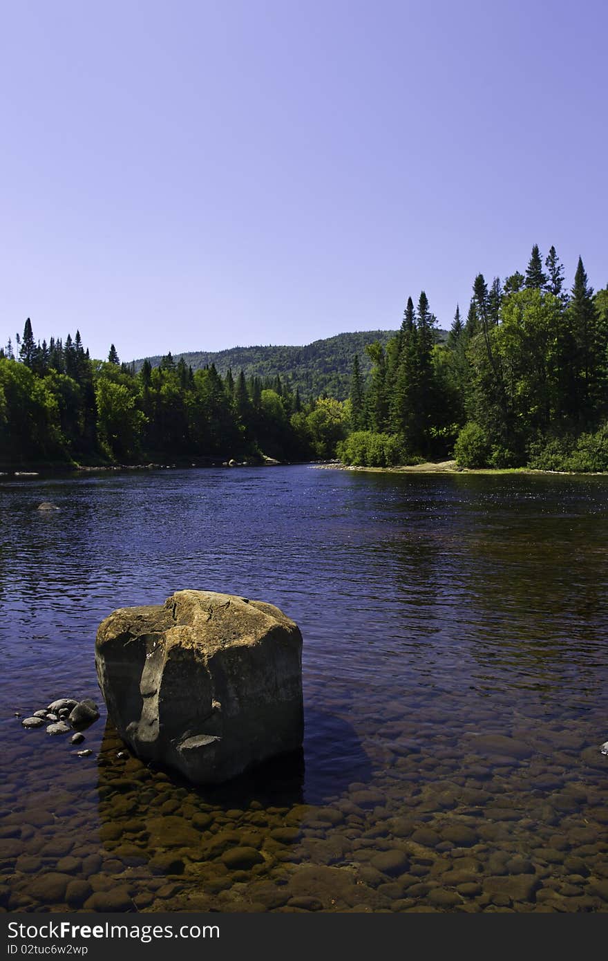 Beautiful view from quebec canada. Landscape with river tree mountain and a big stone. Beautiful view from quebec canada. Landscape with river tree mountain and a big stone.