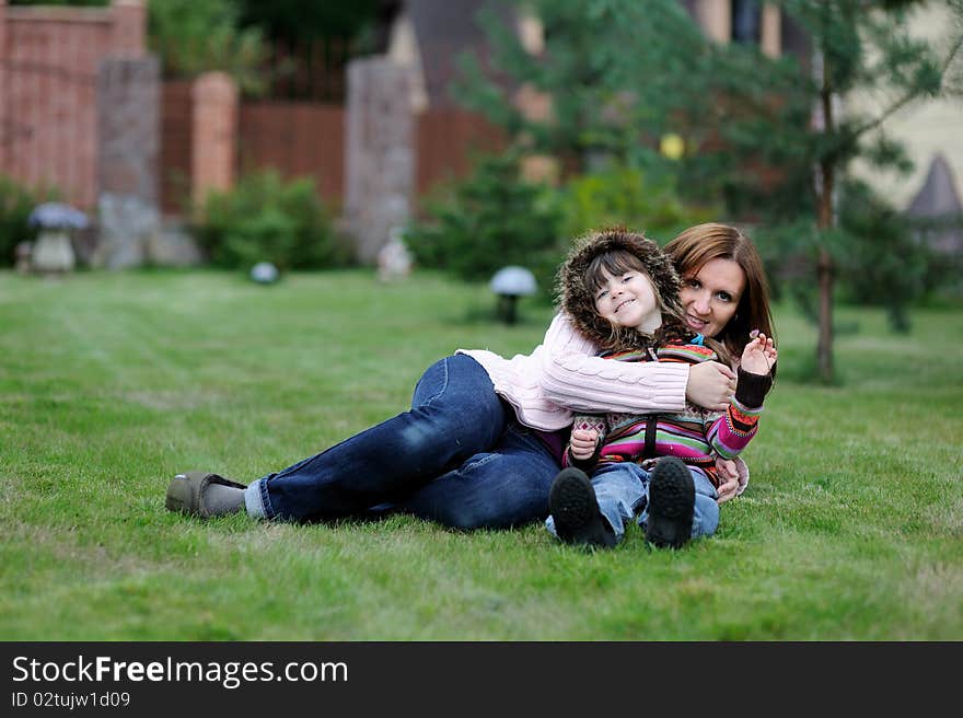 Young mother with her daughter in the garden