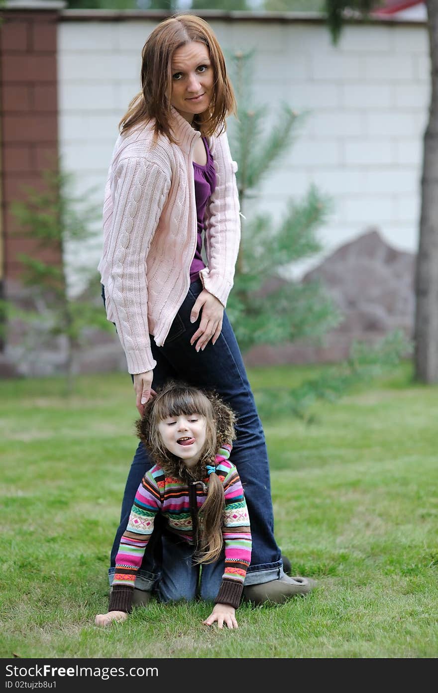 Young mother with her daughter in the garden