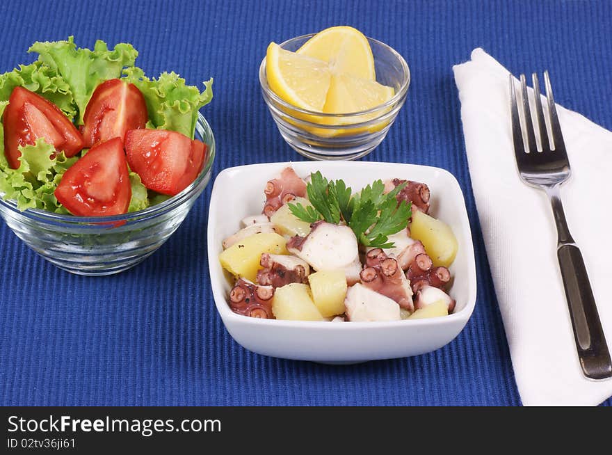 Octopus with potatoes and mixed salad