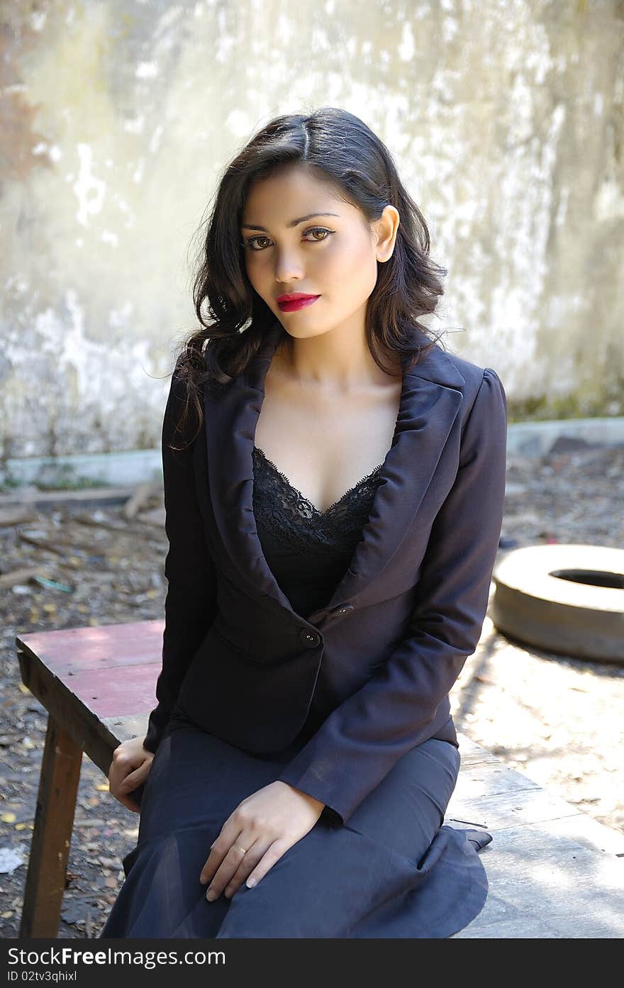 Pretty business woman wearing black suit, posing at outdoor. Pretty business woman wearing black suit, posing at outdoor