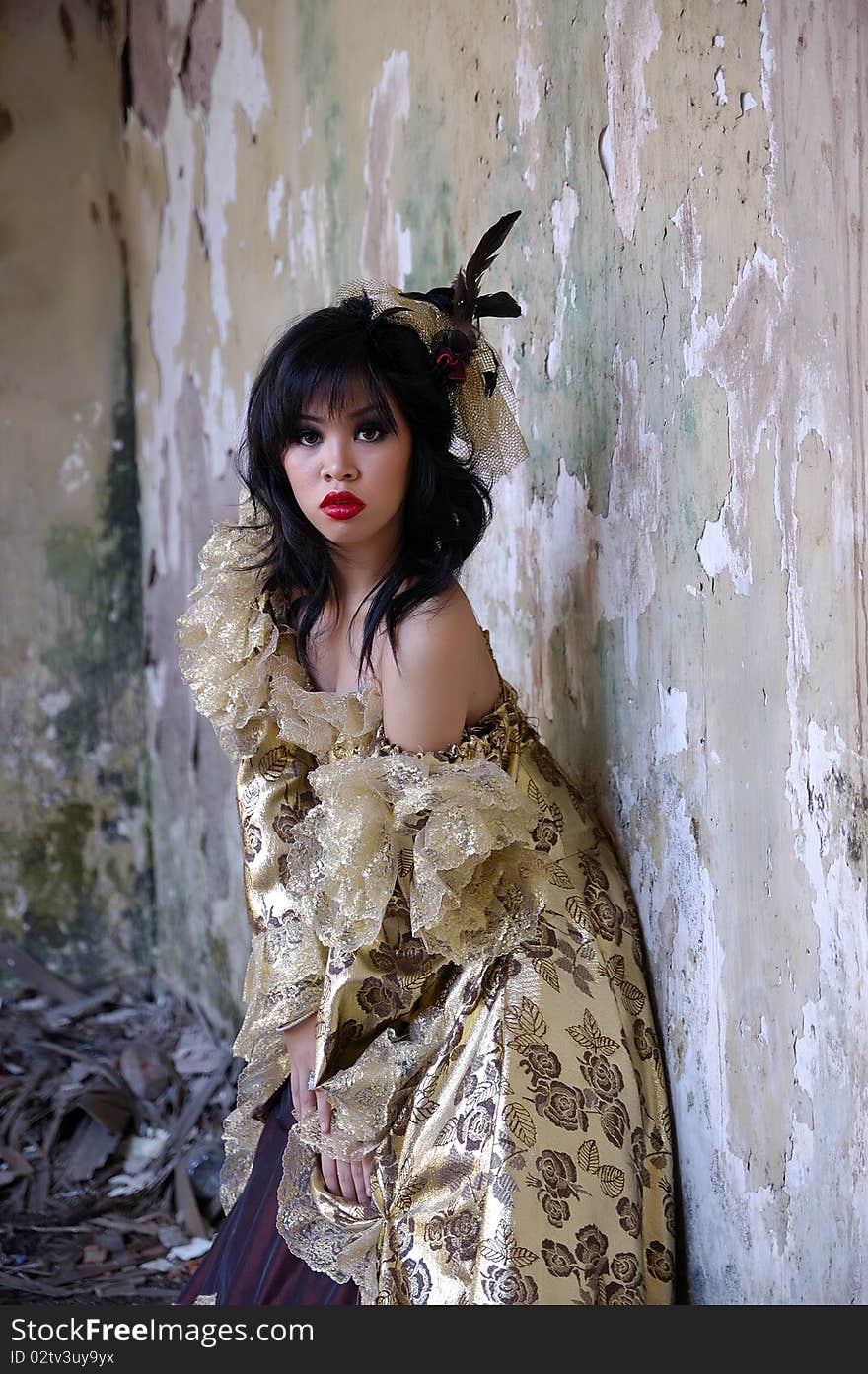 Chinese woman wearing victorian costume shoot at grunge building. Chinese woman wearing victorian costume shoot at grunge building