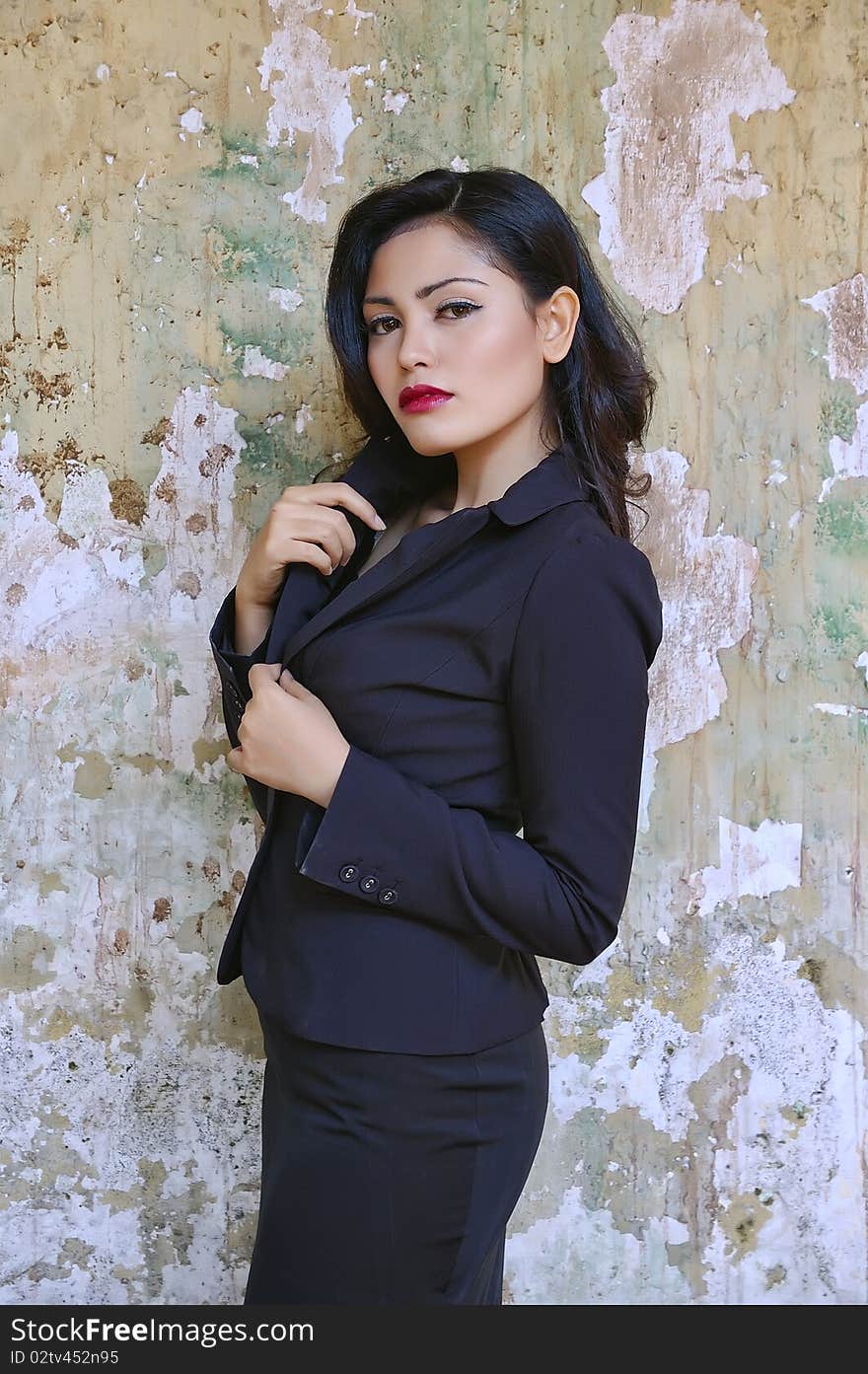 Pretty business woman wearing black suit, posing at outdoor. Pretty business woman wearing black suit, posing at outdoor