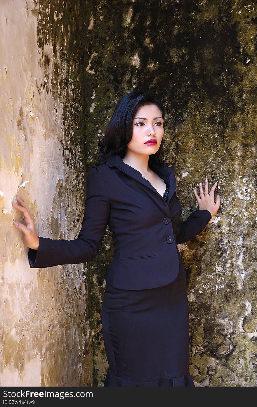 Pretty business woman wearing black suit, posing at outdoor. Pretty business woman wearing black suit, posing at outdoor