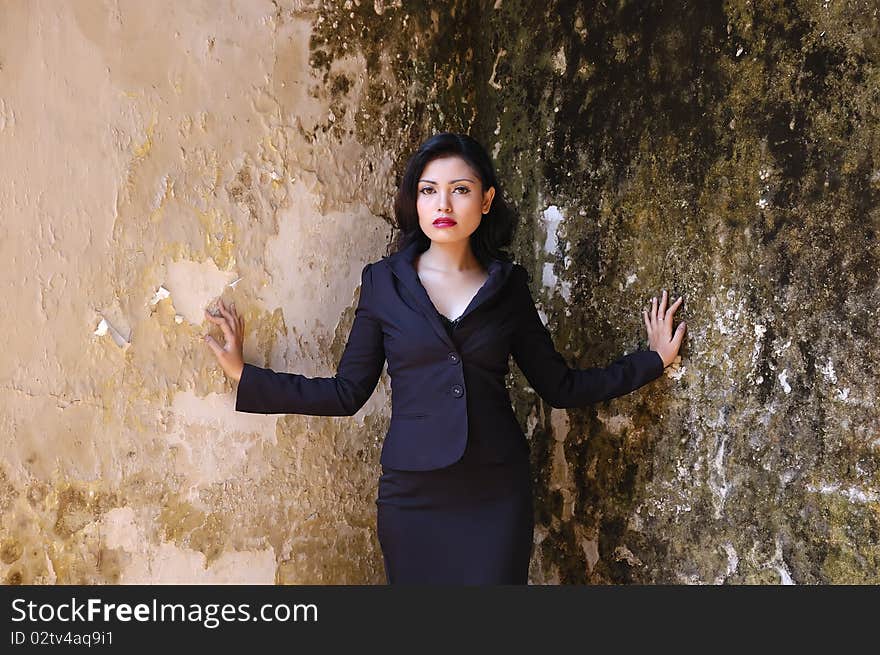 Pretty business woman wearing black suit, posing at outdoor. Pretty business woman wearing black suit, posing at outdoor