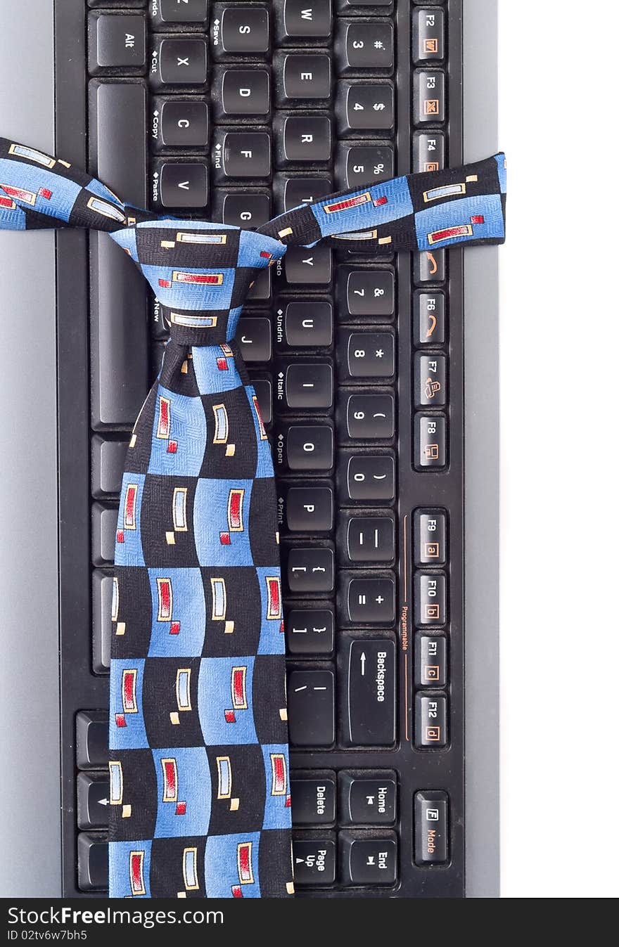 Neck Tie Around Computer Keyboard for business fashion/professional attire concepts. Neck Tie Around Computer Keyboard for business fashion/professional attire concepts