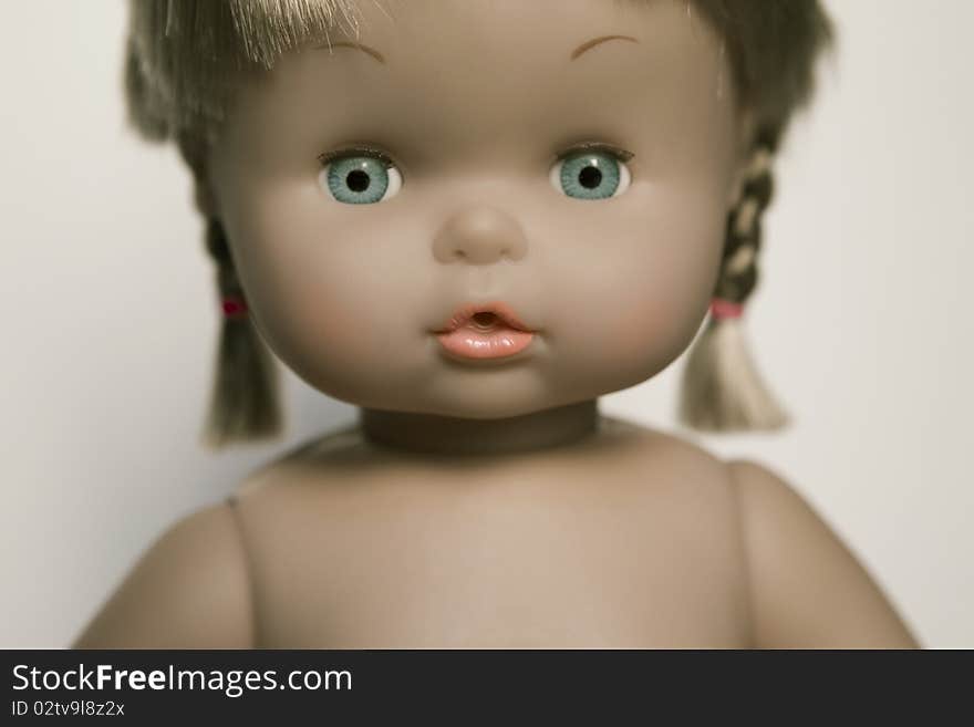 Closeup of doll's face with blue eyes