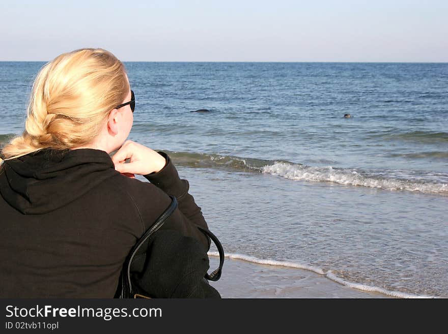 Girl Watching Seals At The Coast Of Helgoland