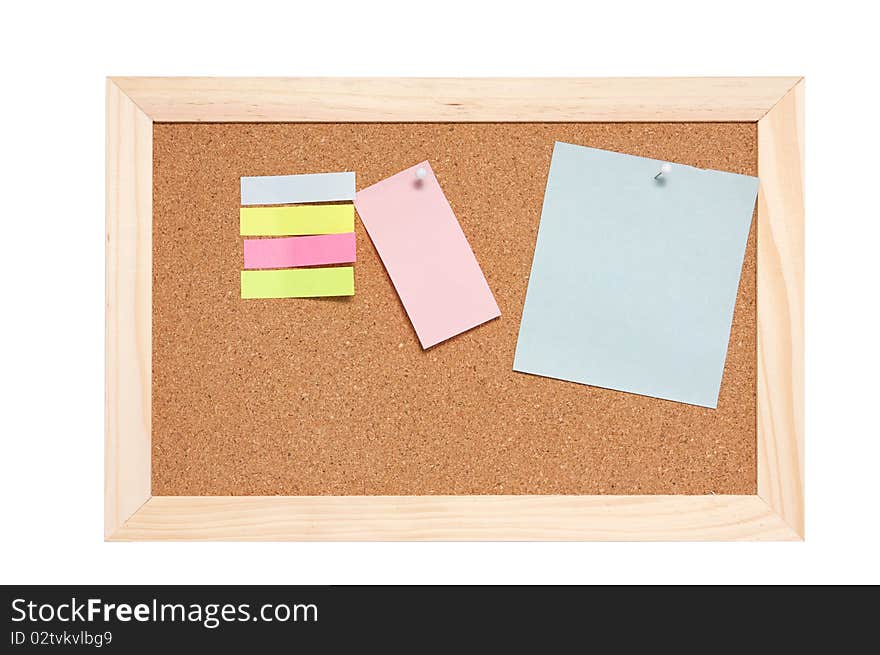 Corkboard with empty blue pink and yellow notes