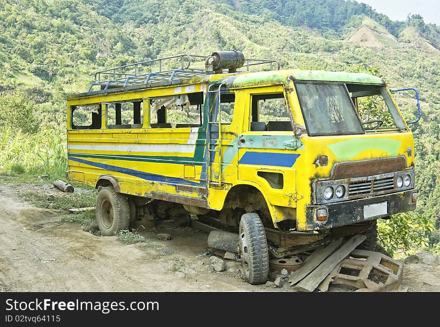 An old, dilapidated vehicle by the side of the road. An old, dilapidated vehicle by the side of the road