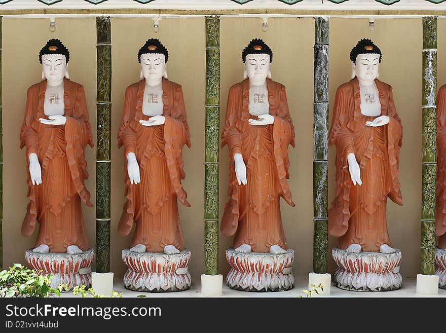 A row of Buddhas at the Kek Lok Si temple, in Penang, Malaysia. A row of Buddhas at the Kek Lok Si temple, in Penang, Malaysia