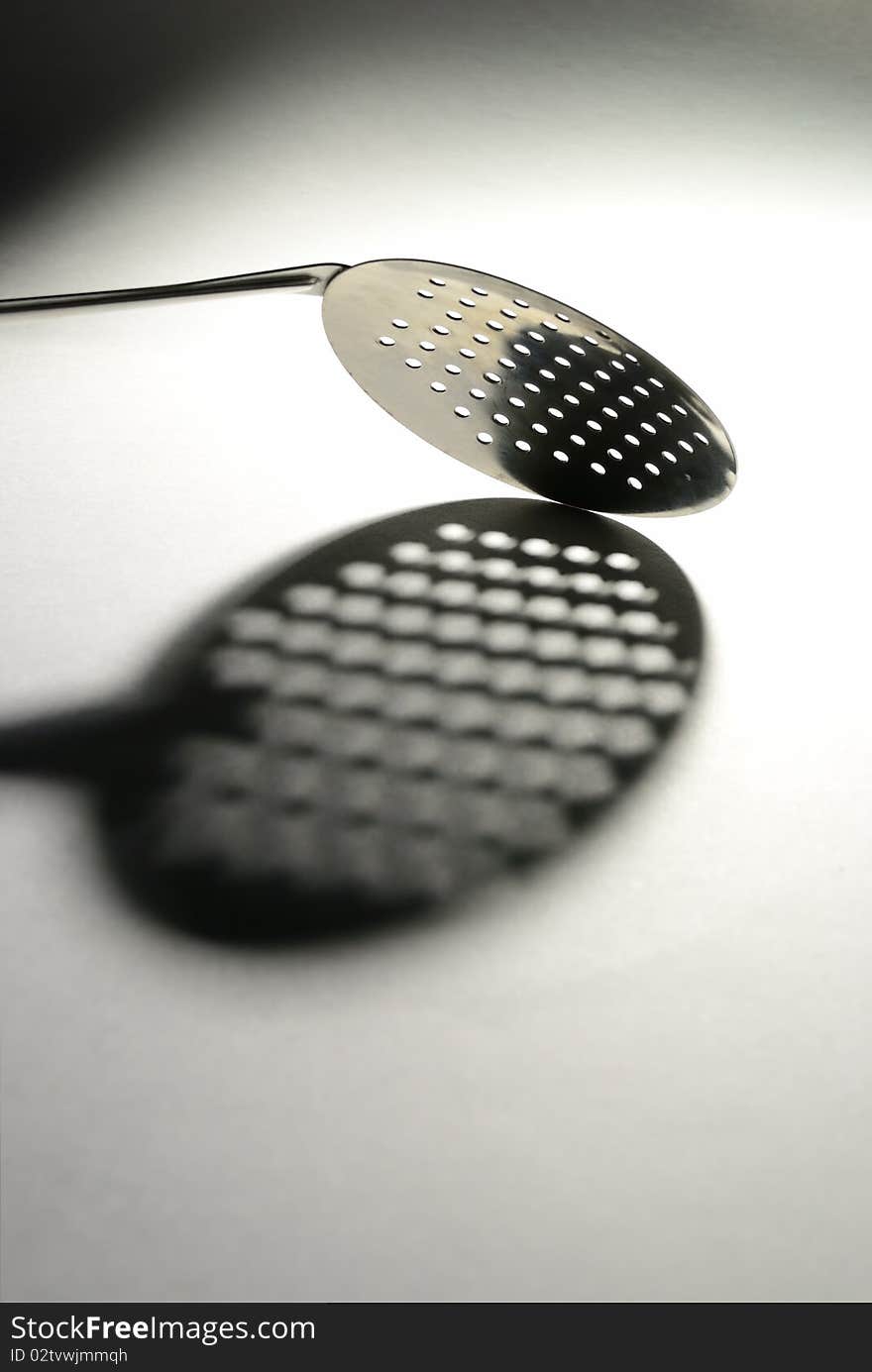 Kitchen spoon and her shade on a white background. Kitchen spoon and her shade on a white background