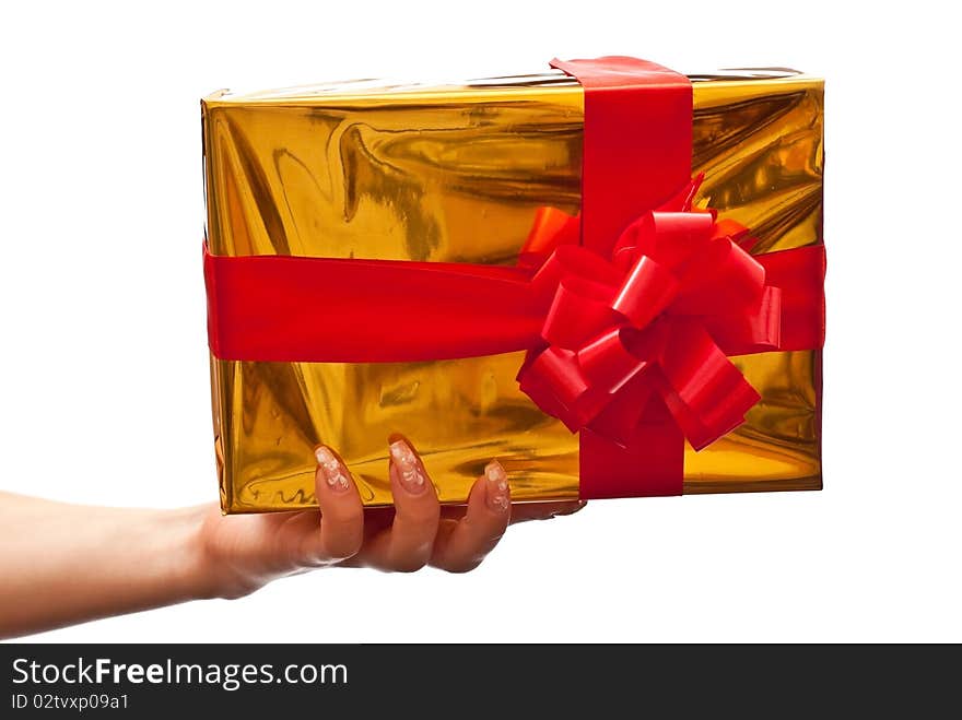 Female hand holding a yellow christmas gift. Isolated on white background. Female hand holding a yellow christmas gift. Isolated on white background