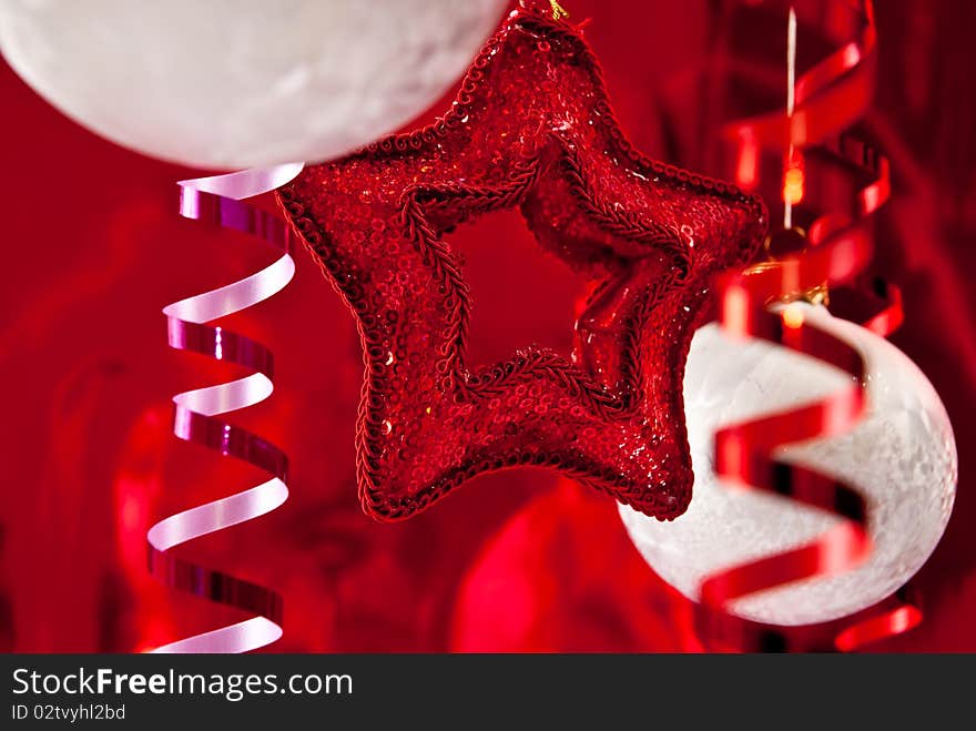 Beautiful christmas star and white baubles on red background