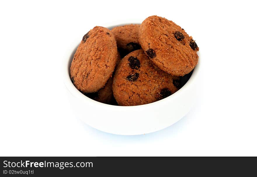 Chocolate cookies in a bowl, isolated on white background