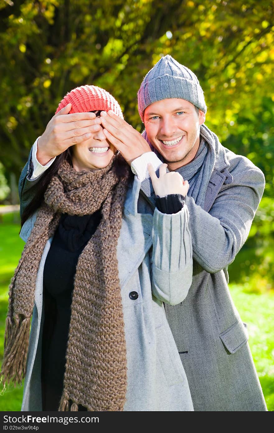 Embracing laughing love couple in autumn season