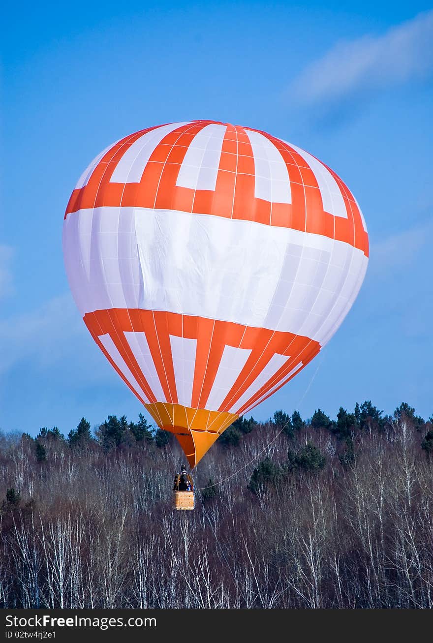 Air ball in flight on background blue sky(heaven) and winter wood. Air ball in flight on background blue sky(heaven) and winter wood