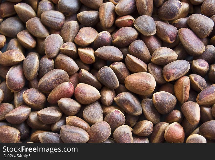 Background from(of;out of) unrefined ripe cedar nut. Background from(of;out of) unrefined ripe cedar nut