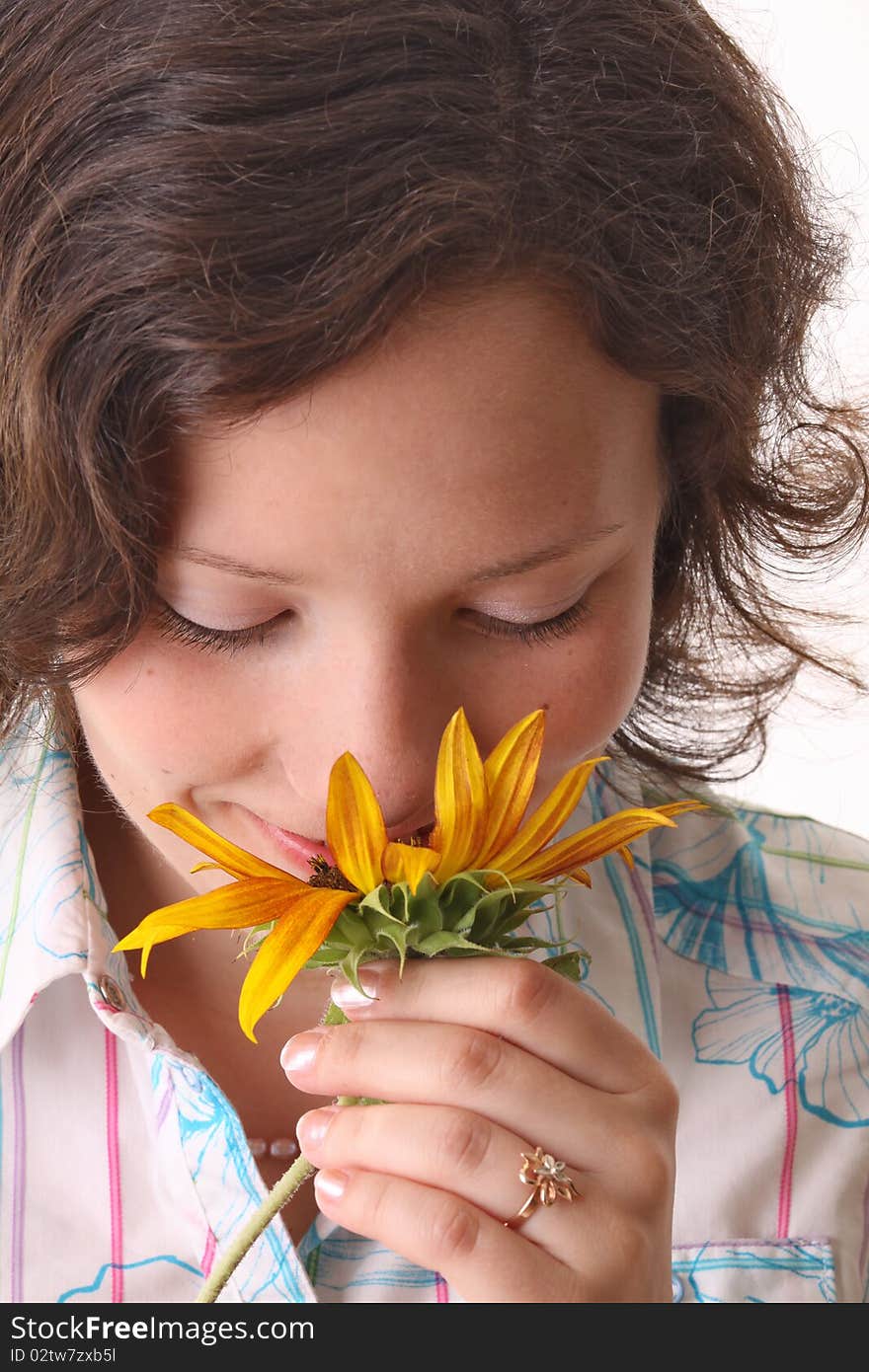 Happy woman sniffs sunflower. Close-up