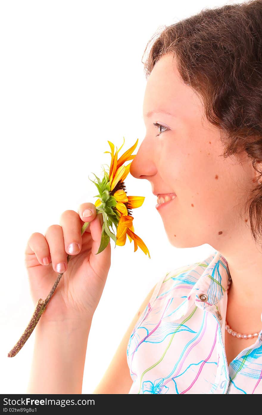 Beautiful girl sniffs a flower