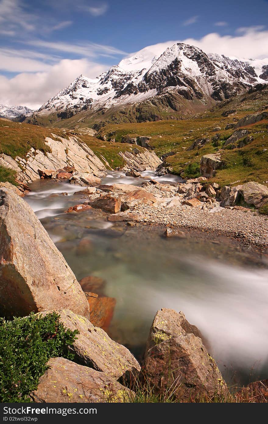 Gavia Pass, Brixia province, Lombardy region, Italy. Gavia torrent at 2651 meters on the sea-level. Tresero peak as background