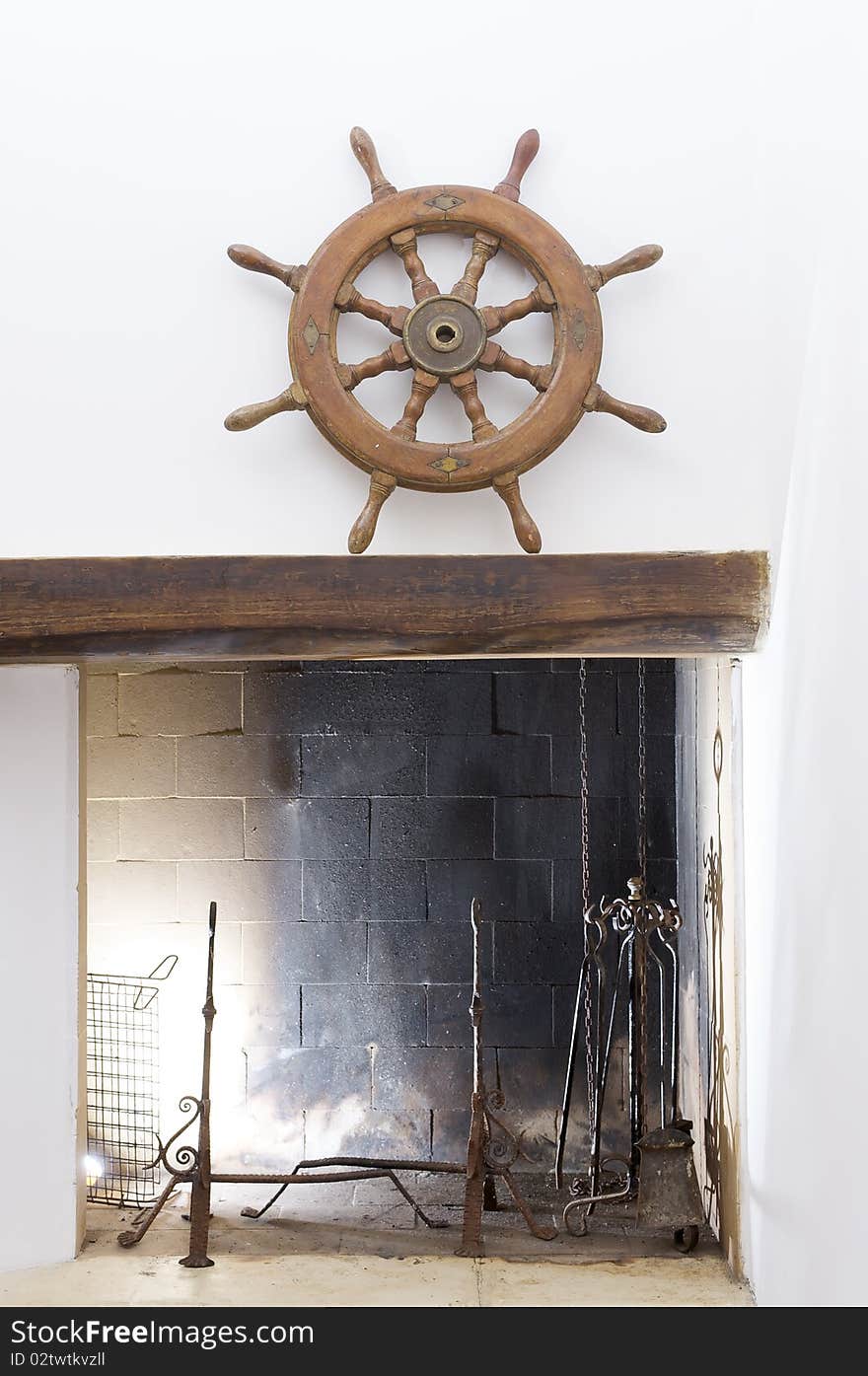 A wheel helm on a fire place