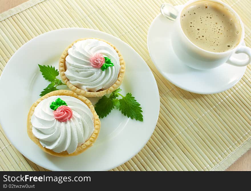 Coffee and two small cakes  with mint. Coffee and two small cakes  with mint