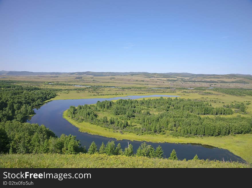 The curving river in the summer prairies of Inner Mongolia, China. The curving river in the summer prairies of Inner Mongolia, China