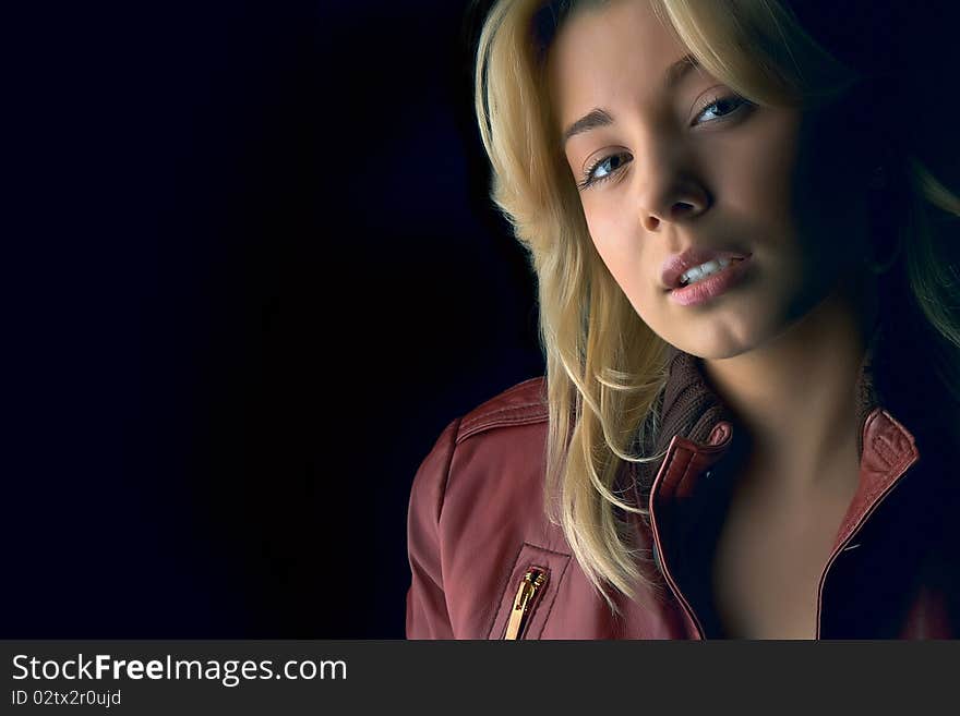 Young beautiful girl in red leather jacket