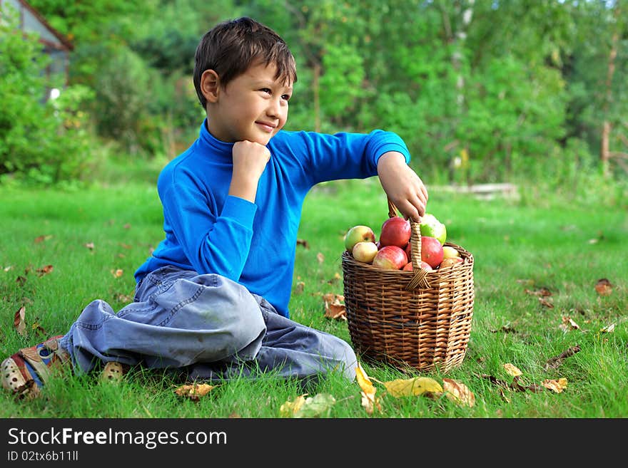 Harvest time - little boy posing outdoors with apples. Harvest time - little boy posing outdoors with apples