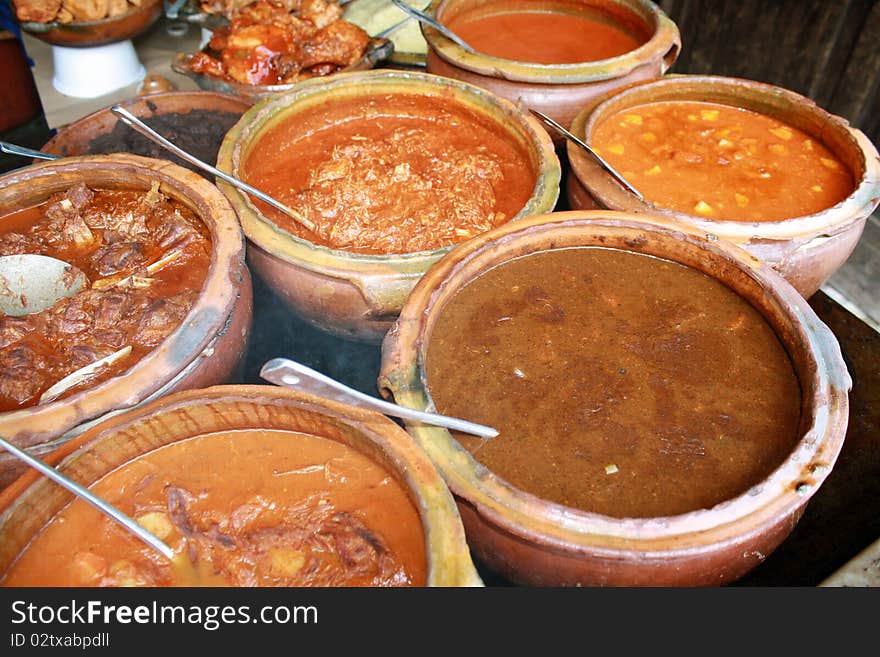 Variety of Guatemalan meat gravies, displayed in traditional earthen bowls. Variety of Guatemalan meat gravies, displayed in traditional earthen bowls.