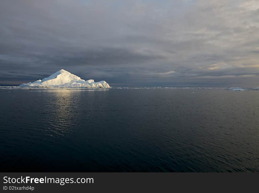 Iceberg in the famous icefjord beside the city of Ilulissat in Greenland. The icefjord is on UNESCO's World Heritage List. Iceberg in the famous icefjord beside the city of Ilulissat in Greenland. The icefjord is on UNESCO's World Heritage List.