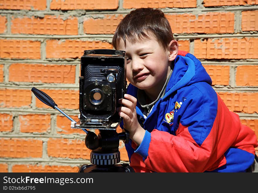 Kid making a shot with retro camera