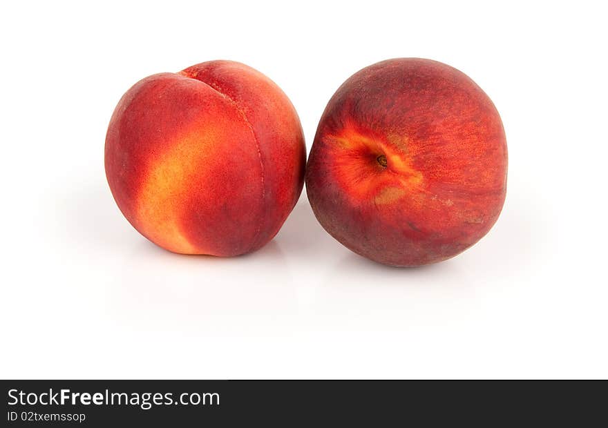 Two juicy peaches isolated on white background