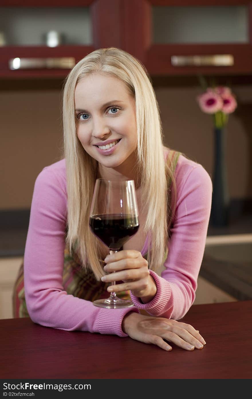 Young attractive woman tasting red wine before dinner. Young attractive woman tasting red wine before dinner