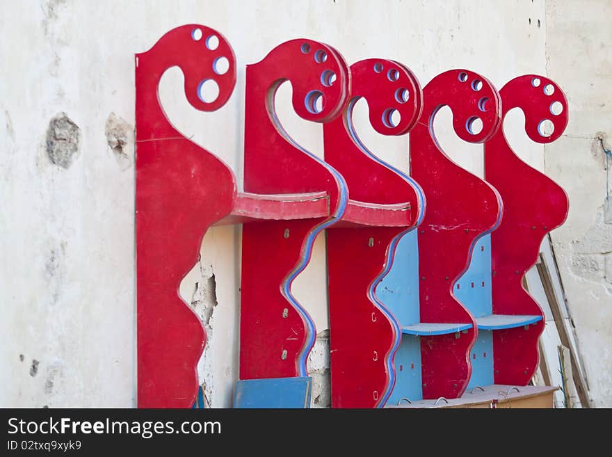 Red-painted boards arranged on a wall