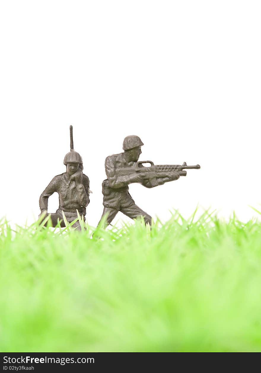 Toy Soldier Gunner Providing Cover for Radio Man on grass for team concepts. Toy Soldier Gunner Providing Cover for Radio Man on grass for team concepts