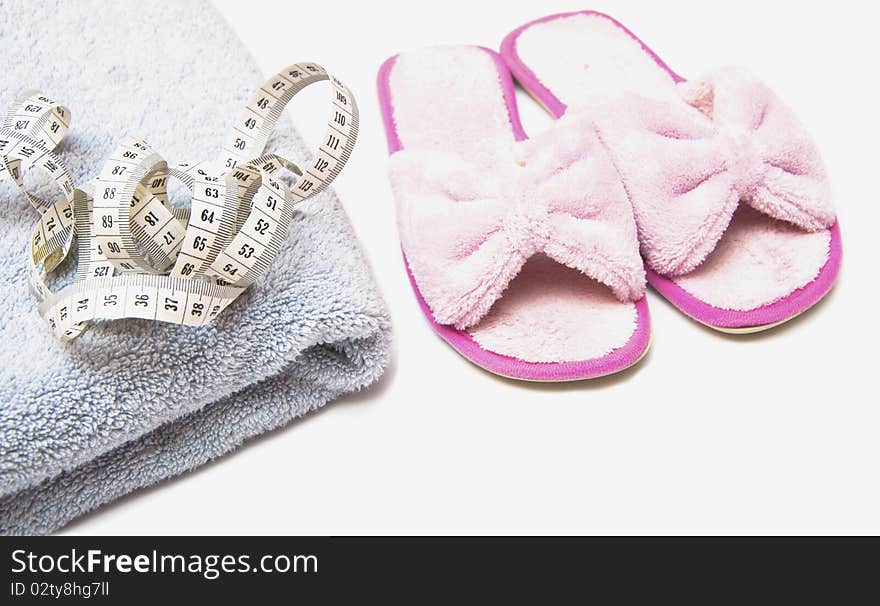 Slippers, Grey Folded Towel And Metr