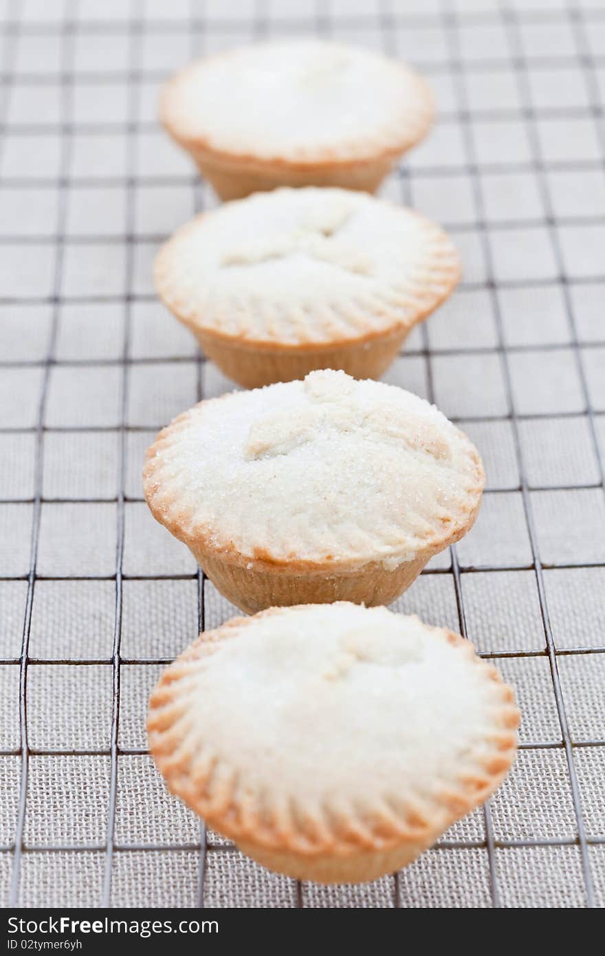 Four freshly baked mini apple pies