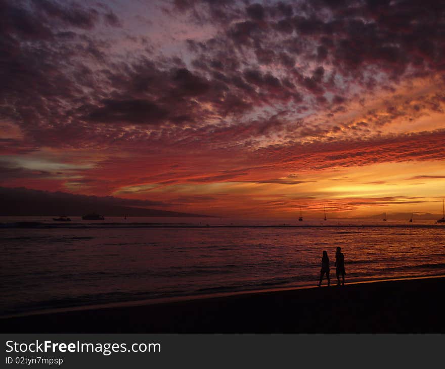 Couple walking on sunset beach. Couple walking on sunset beach