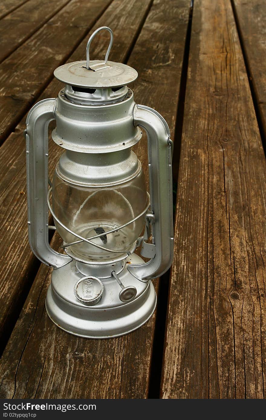 Old kerosene lamp on the old wooden table